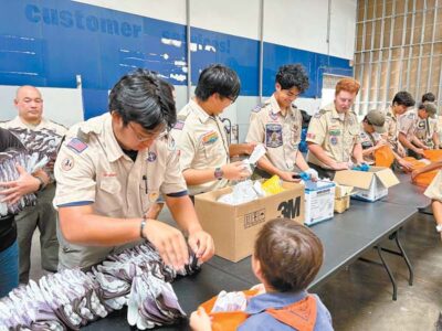 Scouts help pack PPE for fire survivors